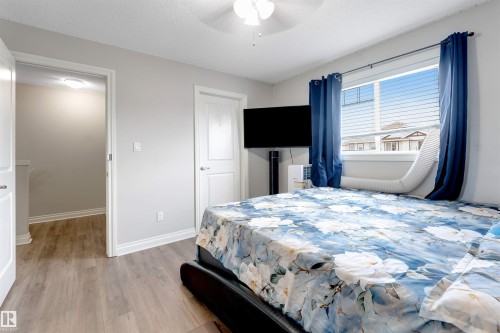 Wood-finish flooring throughout, white trim and doors, and a ceiling fan with integrated lighting - 3106 15 Avenue Nw, Edmonton, AB - Indoor Photo Showing Bedroom