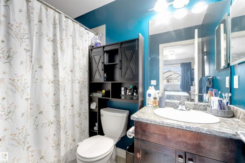 Vanity with a single basin and patterned countertop - 3106 15 Avenue Nw, Edmonton, AB - Indoor Photo Showing Bathroom