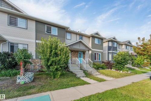 Three-story property with light-colored siding and a contrasting darker accent panel - 3106 15 Avenue Nw, Edmonton, AB - Outdoor With Facade