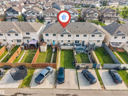 Rear exterior featuring a spacious lawn, wood fencing, and a multi-level deck - 3106 15 Avenue Nw, Edmonton, AB - Outdoor