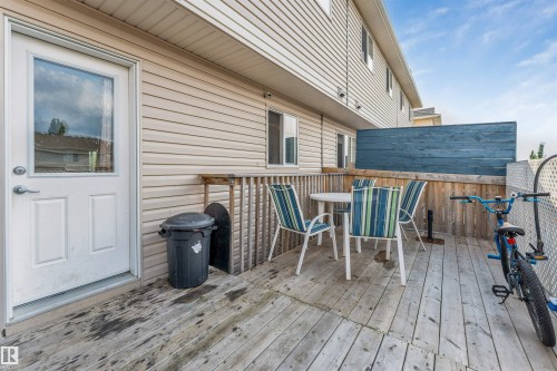 Rear wood deck featuring a privacy screen and exterior door with a glass panel - 3106 15 Avenue Nw, Edmonton, AB - Outdoor With Deck Patio Veranda With Exterior