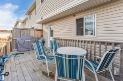 Private wood-fenced deck with a wooden railing and light-colored siding - 