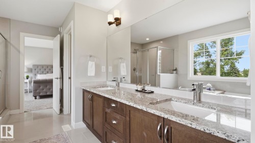 Dual vanity with granite countertops, undermount sinks, and dark wood cabinetry - 63 Rosemount Boulevard, Beaumont, AB - Indoor Photo Showing Bathroom
