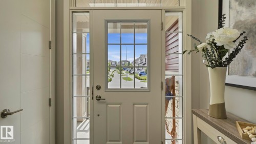 Entry door with glass paneling, sidelights, and transom window - 63 Rosemount Boulevard, Beaumont, AB - Indoor Photo Showing Other Room