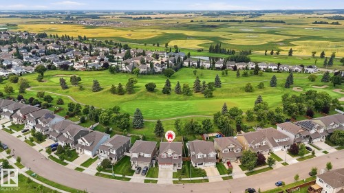 Established residential community featuring tree-lined streets, manicured lawns, and newly constructed homes with traditional architectural styling - 63 Rosemount Boulevard, Beaumont, AB - Outdoor With View