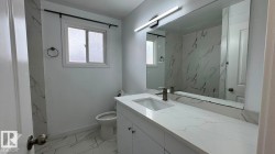 Modern vanity with an integrated sink, quartz countertop, and a large wall-mounted mirror - 