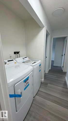 Dedicated laundry area with a top-load washing machine and front-load dryer - 41 Lancaster Terrace Nw, Edmonton, AB - Indoor Photo Showing Laundry Room