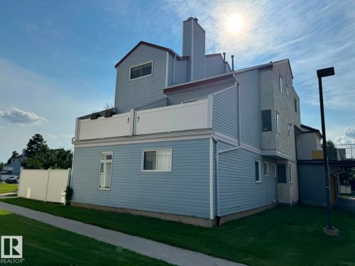 Light blue siding exterior with a white upper-level balcony railing - 41 Lancaster Terrace Nw, Edmonton, AB - Outdoor With Exterior