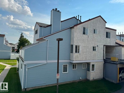 Multi-level exterior featuring light blue siding and textured stucco finishes - 41 Lancaster Terrace Nw, Edmonton, AB - Outdoor With Exterior
