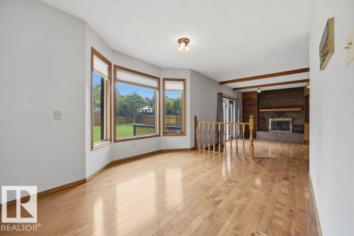 Large Family Room With Brick-faced Wood Burning Fireplace. - 4140 147 Street Nw, Edmonton, AB - Indoor With Fireplace