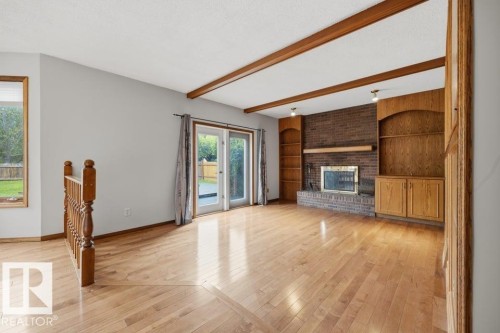 Large Family Room With Brick-faced Wood Burning Fireplace. - 4140 147 Street Nw, Edmonton, AB - Indoor With Fireplace