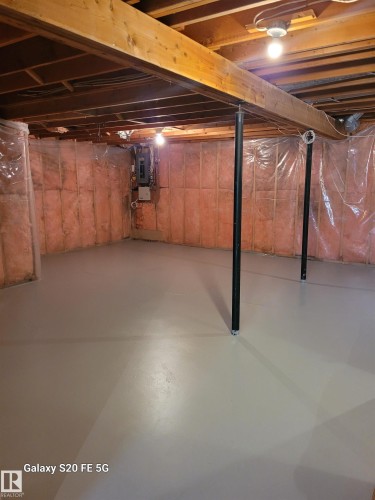 Unfinished basement featuring exposed wood joists, painted concrete floor, and insulated walls - 4140 147 Street Nw, Edmonton, AB - Indoor Photo Showing Basement