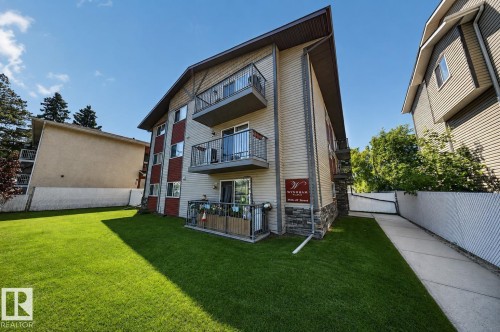 Multi-story building featuring balconies with metal railings, a stone accent facade, and siding - #4 4616 47 St, Leduc, AB - Outdoor
