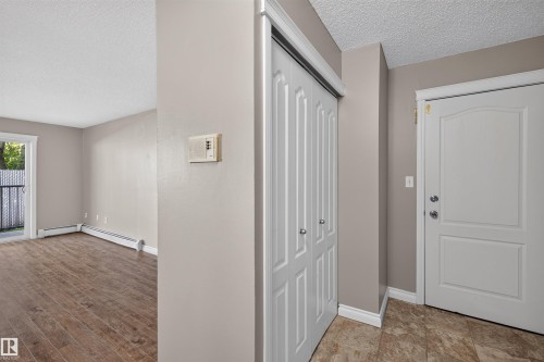 Entryway featuring tile flooring, white paneled door, and bi-fold closet doors - #4 4616 47 St, Leduc, AB - Indoor Photo Showing Other Room
