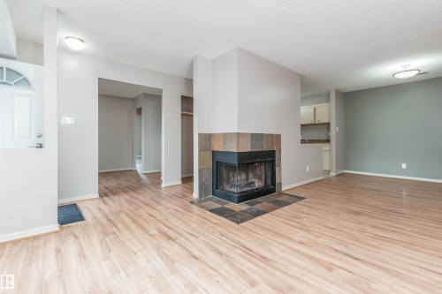 #23 14620 26 St Nw, Edmonton, AB - Indoor Photo Showing Living Room With Fireplace