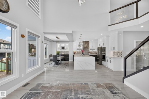 Open concept interior featuring high ceilings and light gray walls - 4703 41 Street, Beaumont, AB - Indoor Photo Showing Other Room