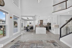 Open concept interior featuring high ceilings and light gray walls - 
