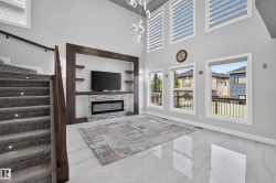 Double-height living area with high ceilings and large windows providing abundant natural light - 