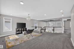 Open-concept upper level featuring gray carpeting and recessed lighting - 