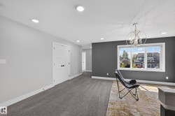 Spacious room featuring gray carpet, recessed lighting, and a prominent window with white trim - 