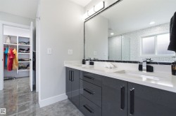 Contemporary double vanity with a sleek dark gray finish, integrated rectangular sinks, and polished chrome faucets - 