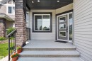 Front entry featuring a contemporary door with frosted glass inserts, a coordinating sidelight, and a large picture window - 4703 41 Street, Beaumont, AB  - Outdoor With Exterior 