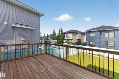 Spacious wooden deck with black metal balusters - 4703 41 Street, Beaumont, AB - Outdoor With Exterior
