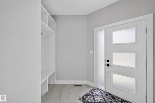 Entryway featuring a white door with three frosted glass panels and a vertical frosted sidelight - 4703 41 Street, Beaumont, AB - Indoor Photo Showing Other Room