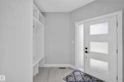 Entryway featuring a white door with three frosted glass panels and a vertical frosted sidelight - 