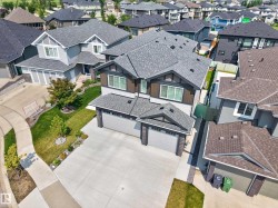 Contemporary two-story residence featuring a dual-tone exterior with dark siding and light gray accents - 