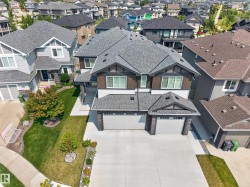 Modern two-story residence with a dual-tone facade and a prominent multi-gable roofline - 