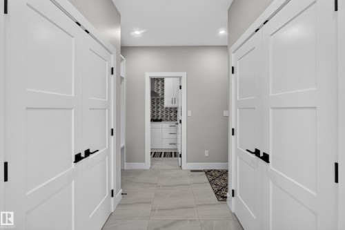 Hallway featuring light-toned tile flooring and recessed lighting - 4703 41 Street, Beaumont, AB - Indoor Photo Showing Other Room