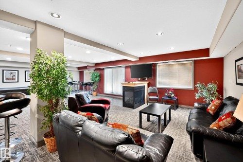 #221 279 Suder Greens Dr Nw, Edmonton, AB - Indoor Photo Showing Living Room With Fireplace