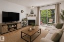 #221 279 Suder Greens Dr Nw, Edmonton, AB  - Indoor Photo Showing Living Room With Fireplace 