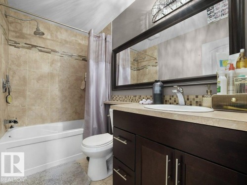 Built-in bathtub with subway tile surround and decorative mosaic accent - 34 Amberly Court Nw, Edmonton, AB - Indoor Photo Showing Bathroom