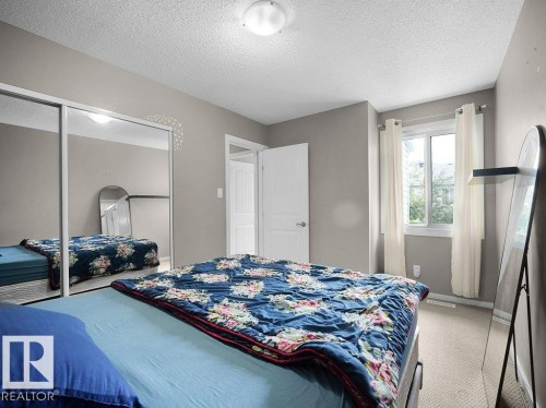 Recessed window with white trim, wall-to-wall carpeting, and a flush-mount ceiling light - 34 Amberly Court Nw, Edmonton, AB - Indoor Photo Showing Bedroom