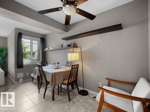 Ceiling fan, recessed lighting, double-pane window, wall-mounted shelving, and tile flooring - 34 Amberly Court Nw, Edmonton, AB - Indoor Photo Showing Dining Room
