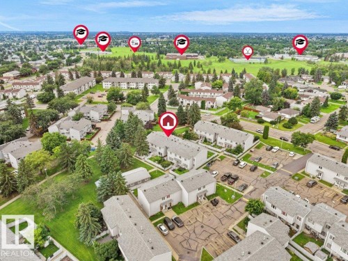 Aerial view showcasing a well-established residential community featuring mature landscaping, tree-lined streets, and spacious lots with multi-family apartment complexes and single-family homes throughout the neighborhood - 34 Amberly Court Nw, Edmonton, AB - Outdoor With View