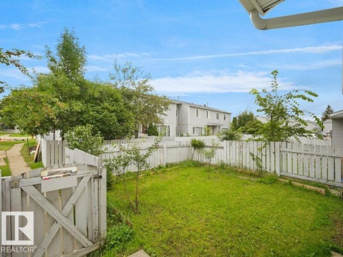 Fenced backyard featuring a grass lawn and a gate - 34 Amberly Court Nw, Edmonton, AB - Outdoor