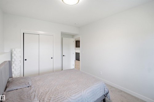 White walls with white trim, carpeting, and flush mount ceiling lighting - 5493 Kootook Road Sw, Edmonton, AB - Indoor Photo Showing Bedroom