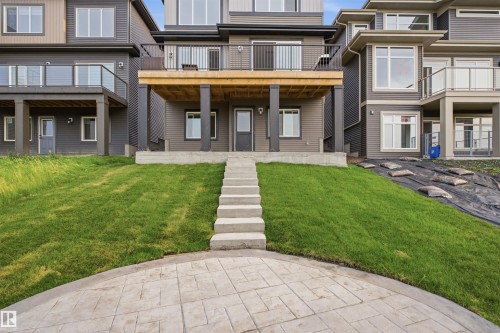 Stamped concrete patio with concrete steps leading to the main level - 5493 Kootook Road Sw, Edmonton, AB - Outdoor With Deck Patio Veranda With Facade