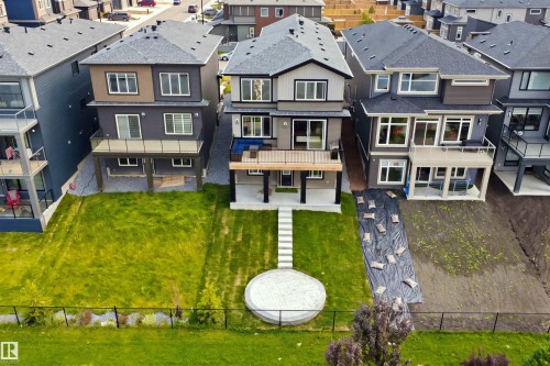 Multi-level contemporary exterior with multiple balconies, a lower-level patio, and extensive rear-facing windows - 5493 Kootook Road Sw, Edmonton, AB - Outdoor