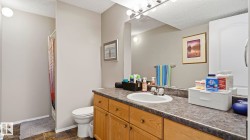 Bathroom vanity featuring a single basin sink, a durable countertop, and wood-finish cabinetry providing ample storage - 