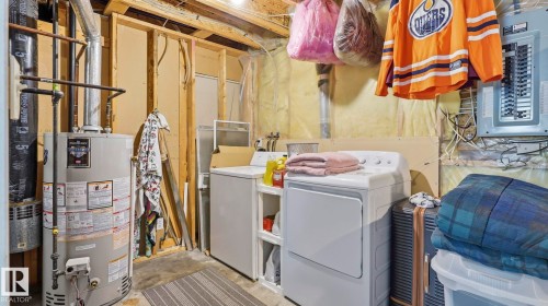 Laundry area with water heater, washer, and dryer - 4105 36A Avenue Nw, Edmonton, AB - Indoor Photo Showing Laundry Room