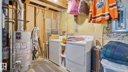 Laundry area with water heater, washer, and dryer - 