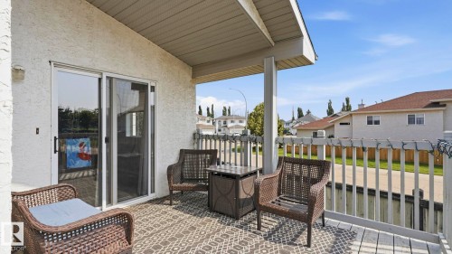 Covered outdoor patio area featuring a textured stucco exterior - 4105 36A Avenue Nw, Edmonton, AB - Outdoor With Deck Patio Veranda With Exterior