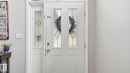White entry door with decorative glass inserts and a sidelight with matching glasswork - 4105 36A Avenue Nw, Edmonton, AB  - Indoor Photo Showing Other Room 