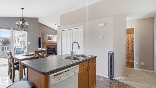 Kitchen island with integrated double basin sink and dishwasher - 4105 36A Avenue Nw, Edmonton, AB - Indoor Photo Showing Other Room