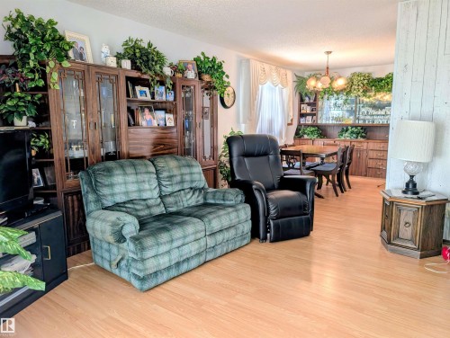 Light wood-finish flooring throughout - 6014 50 Street, Vegreville, AB - Indoor Photo Showing Living Room