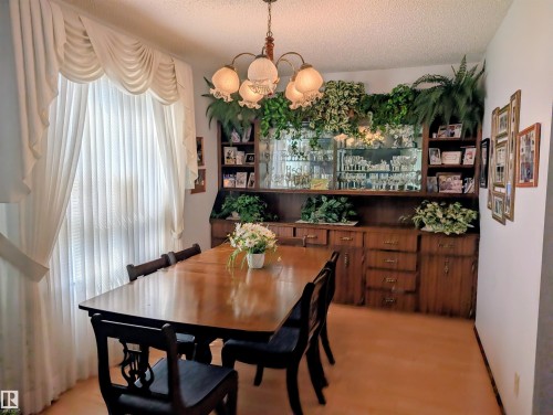Built-in wood cabinetry with glass-front display shelves - 6014 50 Street, Vegreville, AB - Indoor Photo Showing Dining Room